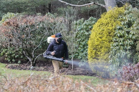 Mosquito technician using a backpack sprayer