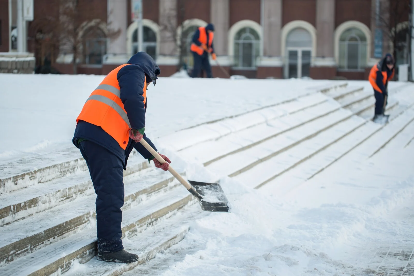 Pure Solutions professionals shoveling snow for a customer