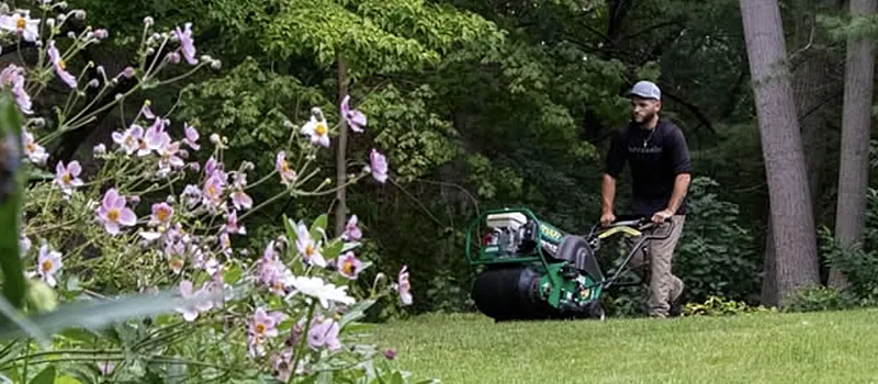 Pure Solutions lawn care employee